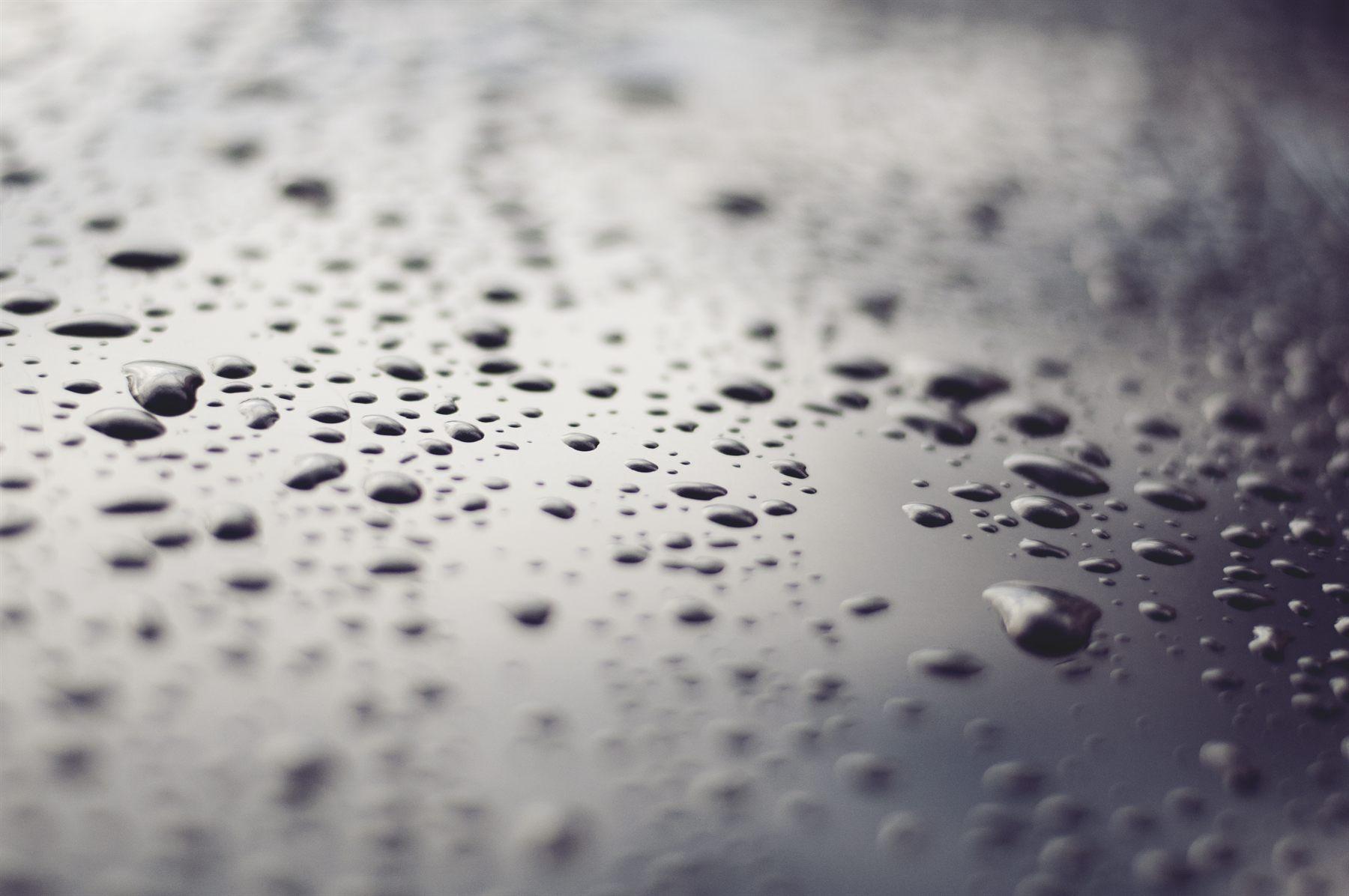 Demo close-up of water beading on a protected metallic surface